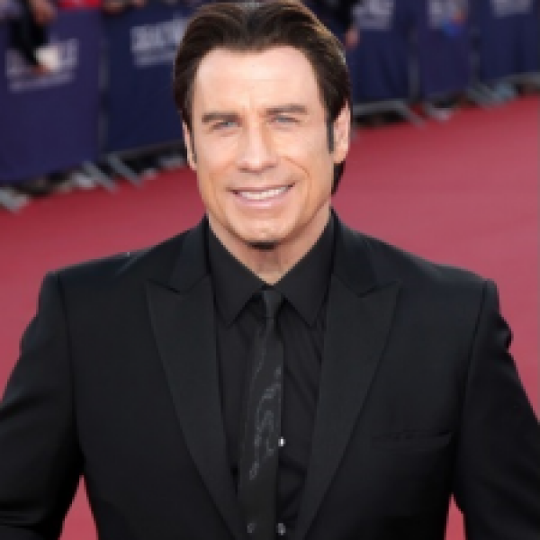 TUNEIN NOTICE John Travolta presents at the 86th Academy Awards